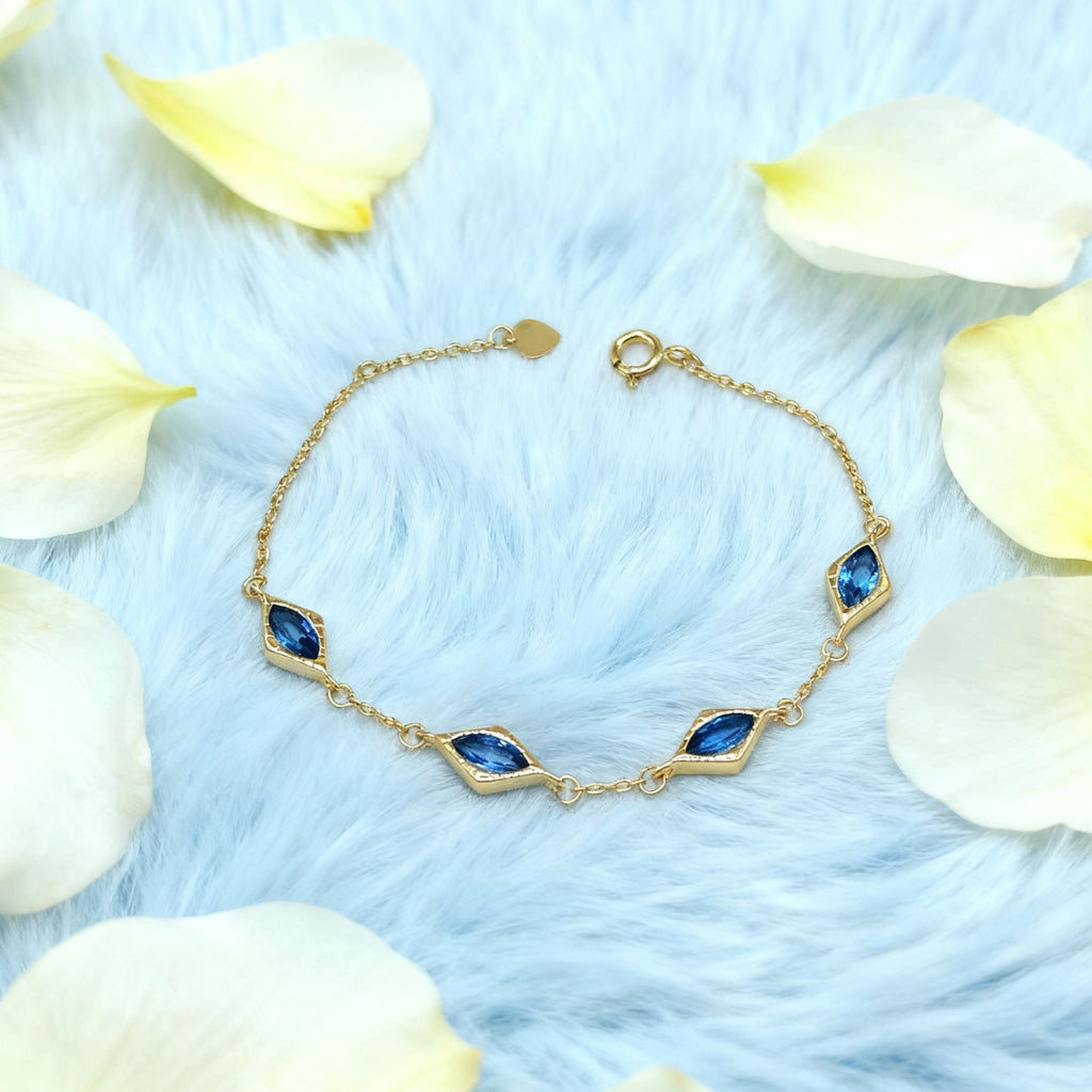 Bracelet « Lien » — Maillons losanges en topaze bleue d'imitation, plaqué or 18 carats