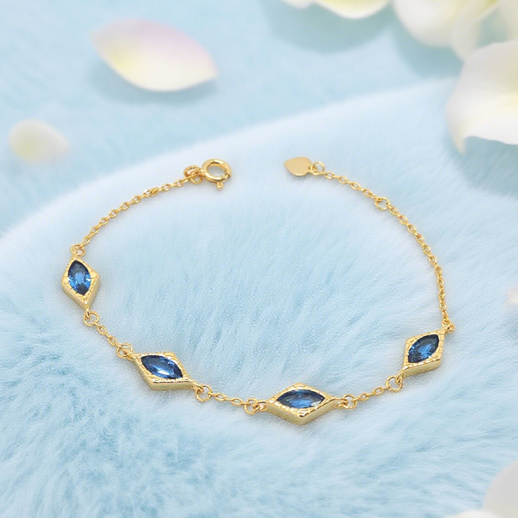 Bracelet « Lien » — Maillons losanges en topaze bleue d'imitation, plaqué or 18 carats